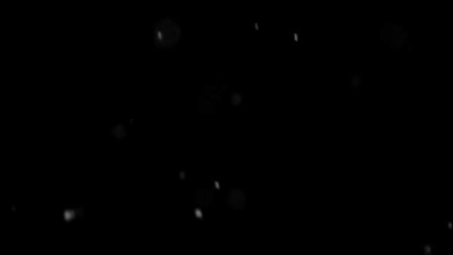 Real filmed snowfall in front of a black background as an overlay video. A telephoto lens with 180 mm focal length creates large round flakes that fall in slow motion.