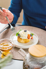 woman eating dessert in cafe