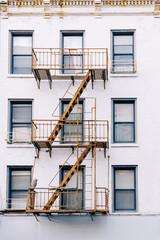 fire escapes are attached to the side of the building as part of a fire escape