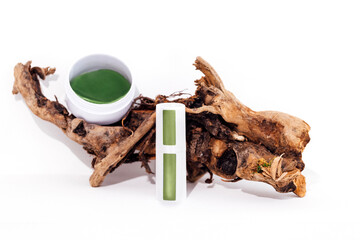 Mock up of cylindrical bottle for cream and plastic jar with green collagen eye patches