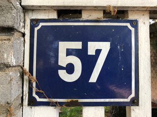 Blue numberplate that says number 57