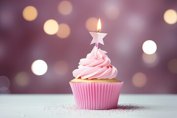 Pink birthday cupcake and candle with gift and party hat on birthday themed background