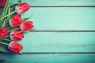 Selective focus on fresh red tulips on turquoise wooden planks Toned image with space for text