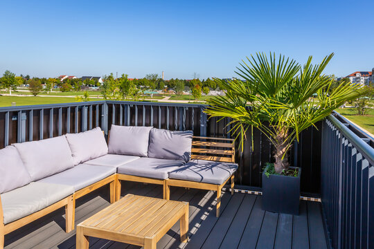 Sitting and relaxing area on roof of  modern city house with green plants