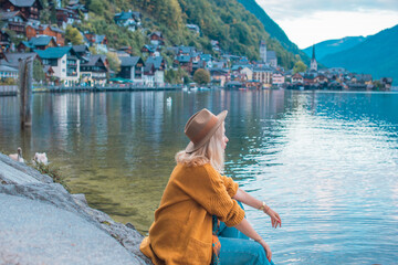 Vacation in Austria. Concept of tourism and holidays. Woman resting in Hallstatt, nature scene
