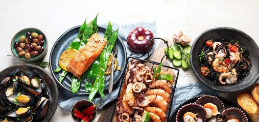 Assortment variousfish dishes - octopus, shrimp, crab, seafood, mussels, salmon. - obrazy, fototapety, plakaty
