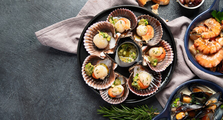 Fried scallops with butter and green sauce served in seashells.