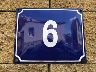 White number six on blue background