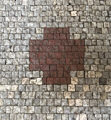 Red Cross made out of cobblestones 