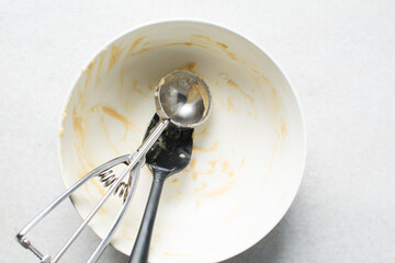 batter in a bowl that has been scraped clean, Leftover cake batter in a white mixing bowl