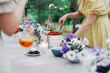 Crop woman cutting cake during banquet