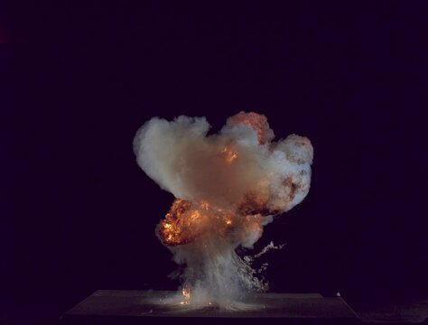 FX element, small explosion shot in slow motion against black, lit to illuminate the smoke, with streaking tendrils. resolution: 2048 x 1556