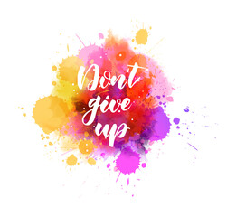 Don't give up - inspirational handwritten modern calligraphy lettering text on abstract watercolor paint splash background. Inspirational text.