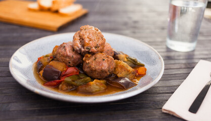 Steamed meatballs with stewed vegetables with haze on plate