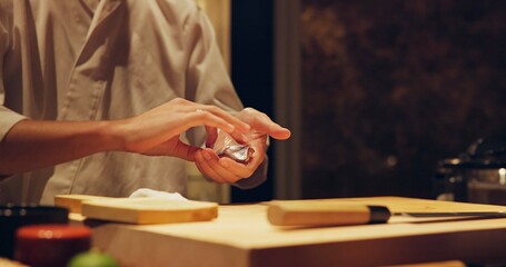 Hands, recipe and chef cooking sushi in restaurant for traditional Japanese cuisine or dish closeup. Kitchen, ingredients for seafood preparation and person working with gourmet food or meal on table