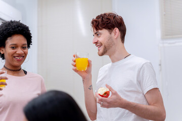 Fototapeta premium A man and woman make a toast with glasses of orange juice, sharing a happy moment. 