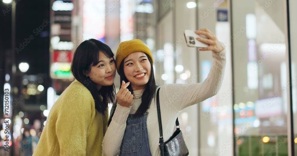 Wall mural Friends, Japanese and selfie with women, smile and excited with blog post, memory and social media. People, smartphone or girls in a street, night and picture with pose, cheerful and bonding together