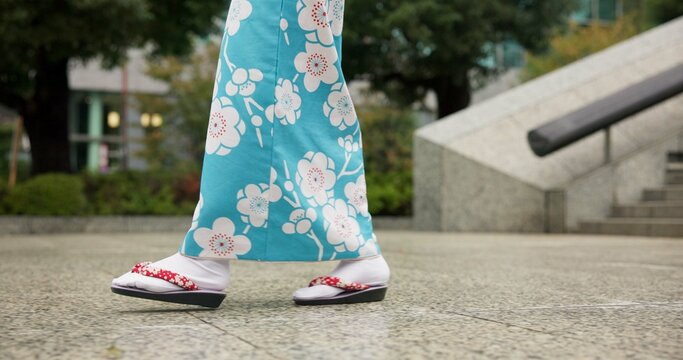 Person, Japanese and feet walking in kimono in city or local commute or traditional, outdoor or downtown. Legs, sandals and Tokyo street or urban road journey as healthy wellness, culture or trip