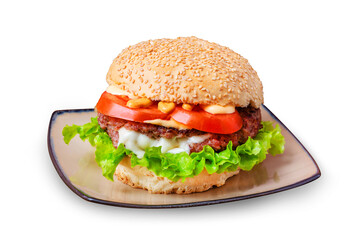 Hamburger with meat cutlet, tomato, cheese sauce and lettuce. Isolated.