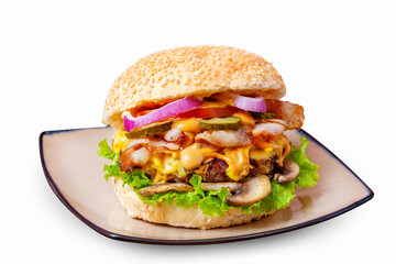 Hamburger with meat cutlet, bacon, tomato, cucumber, mushrooms, onions, cheese sauce and lettuce. Isolated.