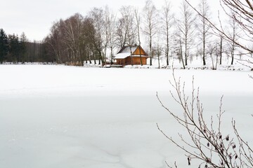 Frozen pond with cottage. Moravia. Czech Republic.