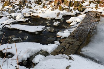  Frozen weir threshold in winter. River Juhyne. Komarno. Eastern Moravia. Czechia. 