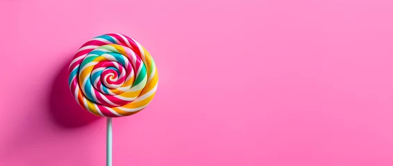 Foto op Plexiglas a sweet and delicious lollipop isolated on pink background with copy space © Denis
