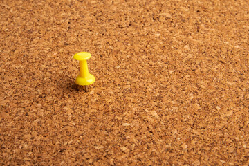 A close up shot of a notice board  with yellow pin