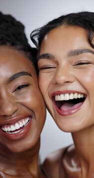 Women, face and beauty with laughing in studio with facial treatment, diversity or glowing skin. Friends, model and portrait with mock up for cosmetics, dermatology and support on white background