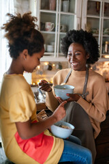 Happy mixed race family, mother daughter spending quality time together, talking