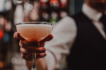 man hand bartender making cocktail in glass on the bar counter