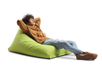 Generation z guy sleeping on a green bean bag armchair