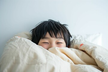 Fototapeta na wymiar ベッドで寝ている日本人の男の子のポートレート（睡眠・うたたね・寝る・快眠・休息・男子・息子）