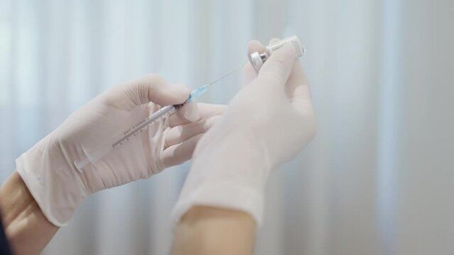preparing botox injection. A dermatologist is drawing a Miotox into a syringe. Elimination of mimic wrinkles with botox. Beauty injections against old age. Elimination of wrinkles