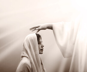 Blessing hand above the head of a woman in a headscarf