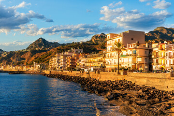 morning sunrise landscape on a city emnarkment with beach and sea coast and beautiful mediterranean street with buildings