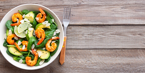Salad with shrimps, avocado, spinach and almonds. Healthy eating. Diet.