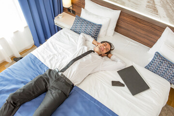Success, good news, businessman celebrating in a hotel room