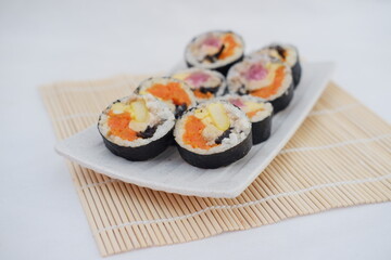 Sushi rolls on a plate on a white background. Japanese food