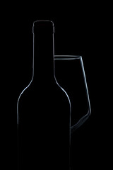 silhouette of wine glass and bottle in black background
