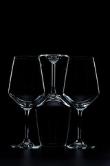 silhouette of wine glasses on black background