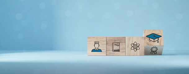 student icons on wooden blocks. Education concept for success.