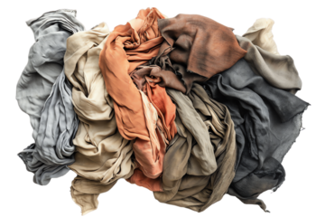 Isolated pile of clothes and assorted waste items including a garbage bag, plastic, and paper, creating a cluttered and environmentally concerning scene