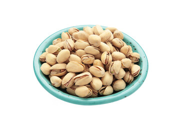 Salted pistachios for beer isolated on white background. Healthy delicious pistachios in plate.