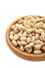 Salted pistachios for beer isolated on white background. Healthy delicious pistachios in wooden plate.