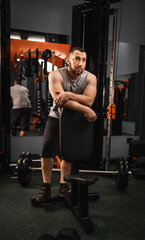 A large bearded man in the gym performs a squat exercise with a barbell. Preparation of a weightlifter for competitions Natural weight gain without the use of steroids.