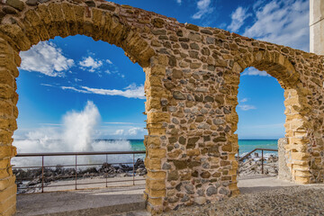 Waves crashing on the rocks of the Cefalù pier, Sicily - 712221766