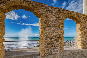 Waves crashing on the rocks of the Cefalù pier, Sicily - 712222524
