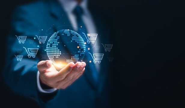 Businessman holding virtual globe with e-commerce icons of shopping for online shopping. Add to cart, internet store, buy online and e-commerce concept. - Powered by Adobe