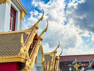 A picture of a Thai temple in bright brass, beautiful with golden Thai pattern.